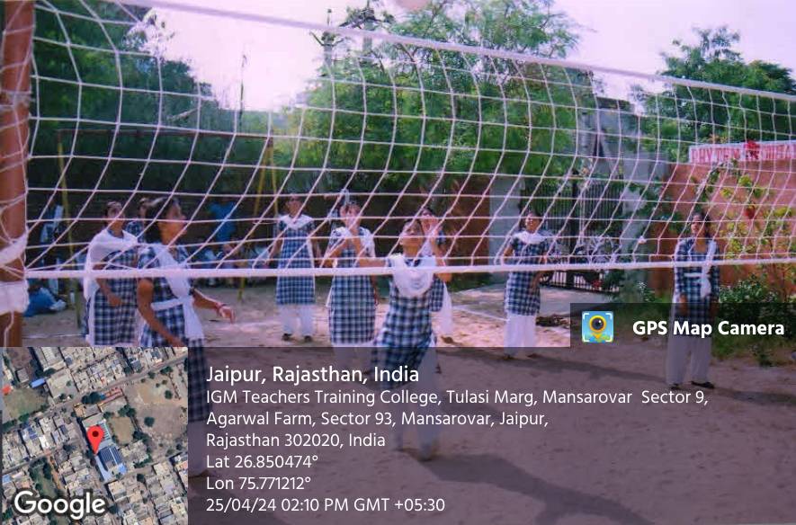 Students in uniform playing volleyball on the college ground