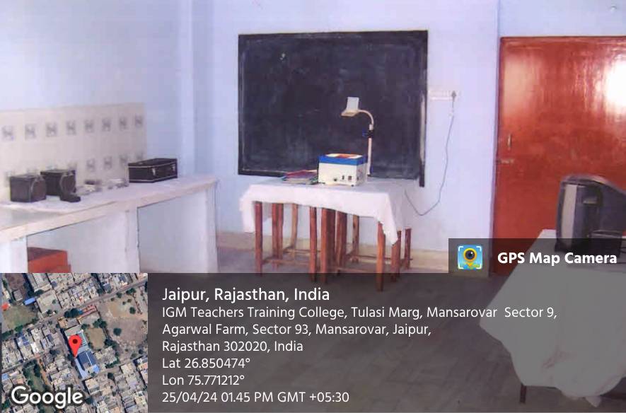 A classroom with a blackboard and an overhead projector on a table