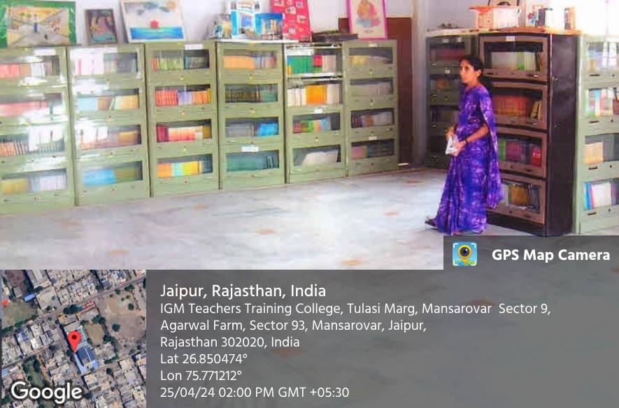 The library, with shelves of books and a teacher walking between them